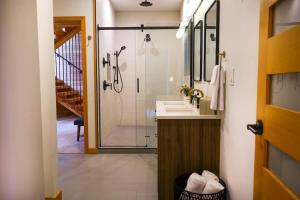 a bathroom with a shower and a sink and a toilet at Aspire at Mount Baker in Glacier +62 photos