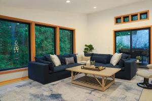 a living room with a blue couch and a coffee table at Aspire at Mount Baker in Glacier