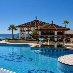 a resort with a swimming pool with a gazebo at Lancaster Palace Tamuda Bay in Marina Smir