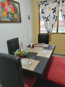 a dining room table with a black tablecloth and chairs at DEPA3 4 personas SanFco in Zacatlán +8 photos