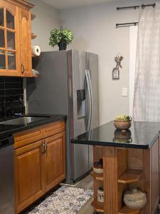 a kitchen with a stainless steel refrigerator and a counter at Country side house with with cozy 3 bedrooms and 2 bath in Minneola +5 photos