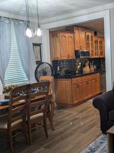 a kitchen with wooden cabinets and a table and chairs at Country side house with with cozy 3 bedrooms and 2 bath in Minneola