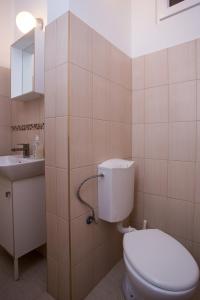 a bathroom with a toilet and a sink at Home Apartment near Blaha Lujza Square in Budapest