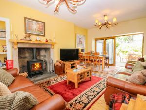 a living room with a couch and a fireplace at St Kilda in Ballater