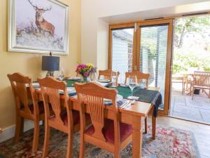 a dining room with a wooden table and chairs at St Kilda in Ballater
