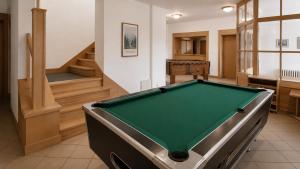 a pool table in a room with stairs at Rennerka Horská bouda in Strážné