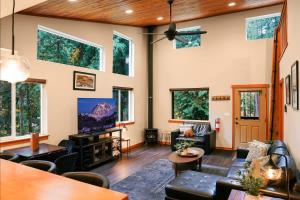 a living room with a lot of windows at Timberline Terrace in Glacier