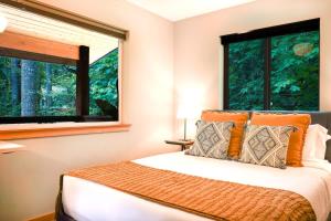 a bedroom with a bed and a large window at Timberline Terrace in Glacier +49 photos