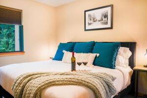 a bedroom with a bed with a bottle of wine on it at Timberline Terrace in Glacier