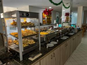 a buffet line with many different types of food at El Aram Ponta Negra in Natal