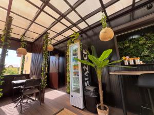 a restaurant patio with a bar and plants at Pokoje Gościnne Orka in Jarosławiec