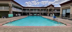 a large swimming pool in the courtyard of a building at Red Roof Inn Bordentown - McGuire AFB in Bordentown