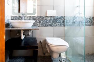 a bathroom with a toilet and a sink at 33A4. Rooftop Studio w Terrace Green Views in Sheikh Zayed +17 photos