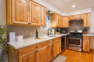 a kitchen with wooden cabinets and a counter top at Colfax Cabin in Glacier