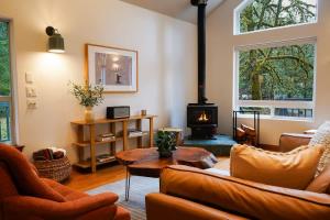 a living room with a couch and a fireplace at Colfax Cabin in Glacier