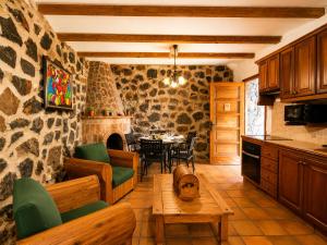 a kitchen and dining room with a stone wall at La Tanquera y Las Rosas in Los Realejos