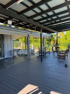 a patio with benches and tables on a deck at Muaicolo House in Suva