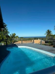 a swimming pool with a view of the ocean at Muaicolo House in Suva