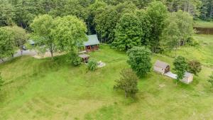 an overhead view of a house in the middle of a field at Log Cabin Fireplace Upper Valley - Wooded Chalet in Hartland
