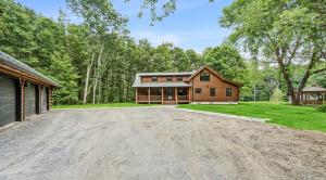 a large driveway in front of a log cabin at Log Cabin Fireplace Upper Valley - Wooded Chalet in Hartland