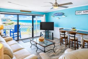 a living room with a couch and a table with a television at Ocean Shores 301 in North Myrtle Beach