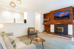 a living room with a couch and a fireplace at Twin Lakes Retreat in Glacier +17 photos