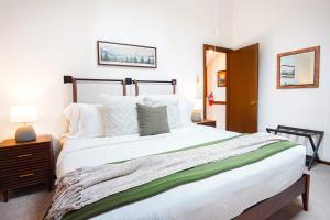 a bedroom with a large white bed with white pillows at Cascade Peaks in Glacier