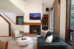 a living room with a couch and a fireplace at Cascade Peaks in Glacier