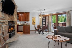a living room with a couch and a fireplace at Winter Park Place #18 in Winter Park +24 photos