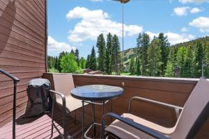 a balcony with a table and chairs and a large window at Winter Park Place #18 in Winter Park