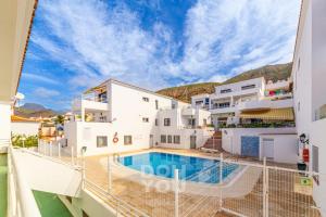 a villa with a swimming pool on the beach at Holiday Apartments Oasis in Los Cristianos