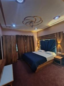 a bedroom with a large bed and a chandelier at The Sapphire Retreat in Srinagar