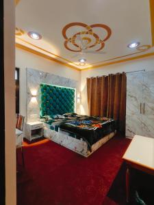 a bedroom with a large bed with a blue headboard at The Sapphire Retreat in Srinagar