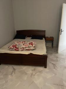 a bedroom with a large bed with a wooden frame at Front de mer salamndre in Mostaganem