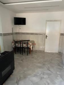 a living room with a table and a television at Front de mer salamndre in Mostaganem