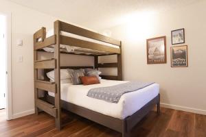 a bedroom with a bunk bed with white sheets at Crystal Creek Retreat in Bellingham