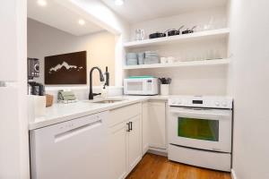 a white kitchen with a sink and a microwave at Crystal Creek Retreat in Bellingham