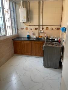 a kitchen with a sink and a stove in it at Front de mer salamndre in Mostaganem