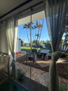 a view of a patio with curtains and a table at VILLA ARATOCA in Garça