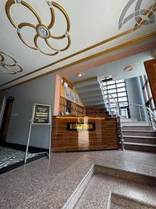 a lobby of a building with a staircase and a sign at The Sapphire Retreat in Srinagar