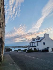 a white house on the side of a street at Bellmullet, Waterside Townhouse in Belmullet