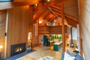 an open living room with a fireplace in a house at Skywood in Deming