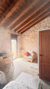 a living room with a wooden door and a table at El Jardín de los Olivos in Fuentesaúco de Fuentidueña
