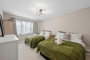 a bedroom with two beds and a window at Spacious Modern home in the heart of Whitefield - Private Driveway Parking in Whitefield