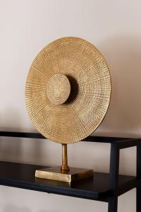 a straw hat on a stand on a table at Town Centre - Elegant Stylish Apartment in Shrewsbury
