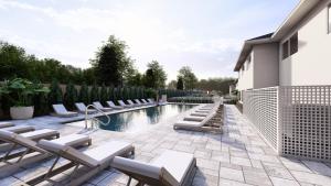 a patio with lounge chairs and a swimming pool at Pell Hotel JdV by Hyatt in Middletown