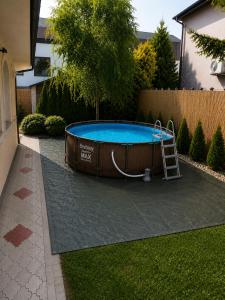 a swimming pool with a ladder in a yard at Villa Acer in Novi Sad