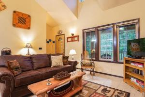 a living room with a brown couch and a table at Hearthstone in Deming