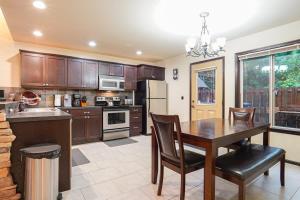 a kitchen with a wooden table and a dining room at Hearthstone in Deming