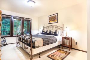 a bedroom with a bed in a room with windows at Hearthstone in Deming +27 photos